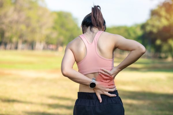 Young adult female with his muscle pain during running. runner woman having back body ache due to Piriformis Syndrome, Low Back Pain and Spinal Compression. Sports injuries and medical concept